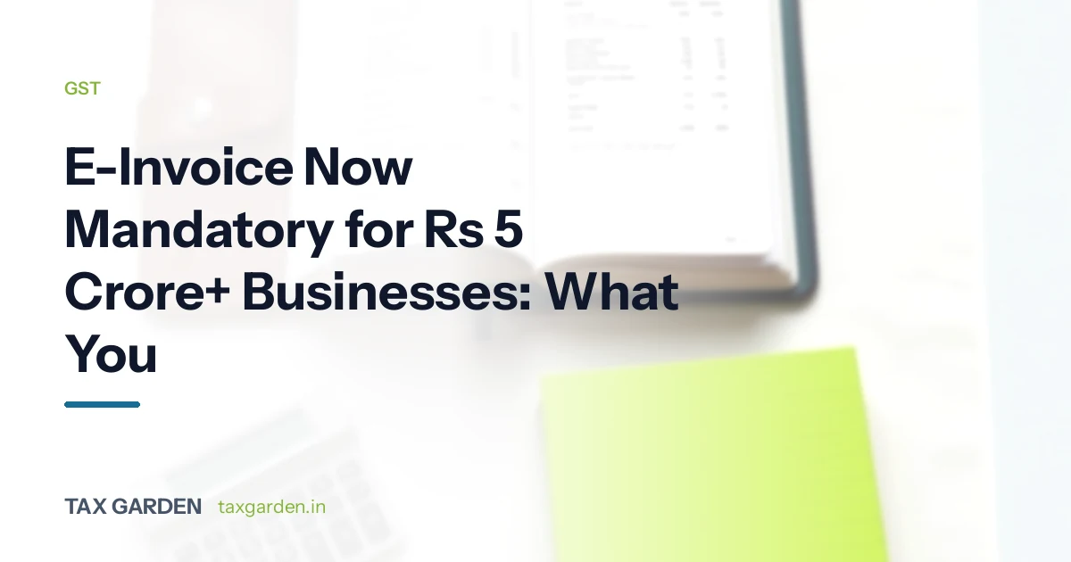 GST e-invoice mandatory for businesses above Rs 5 crore turnover, shown with an invoice book and notepad on a desk
