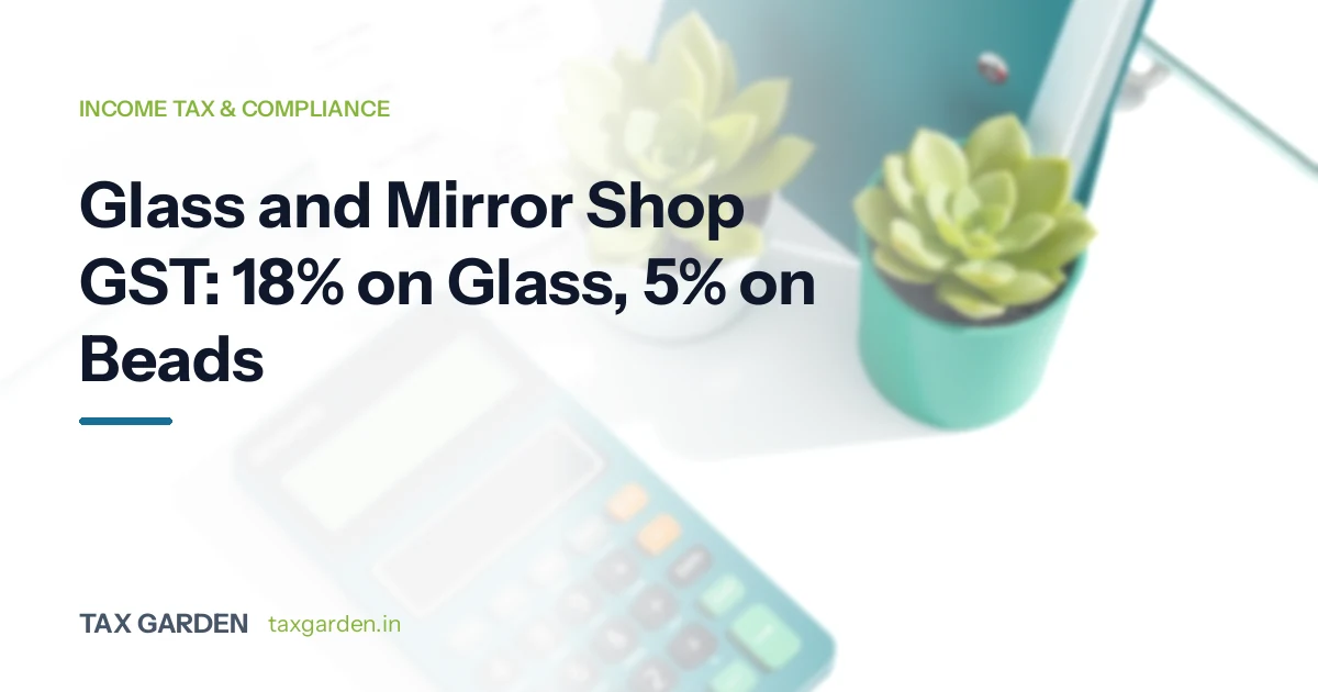 A calculator and potted succulents on a glass desk, for a GST and income tax guide for glass and mirror shops