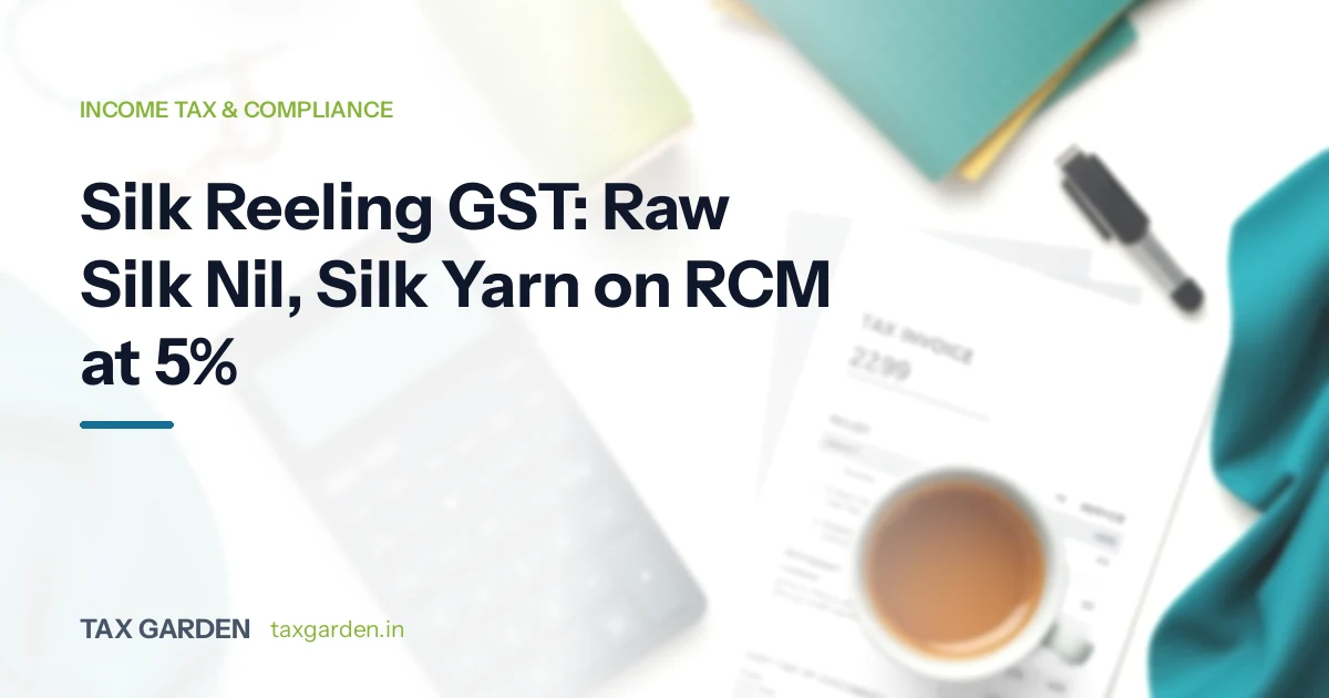Teal silk fabric, a tax invoice, a calculator and tea on a desk, for a GST and income tax guide for silk reeling units